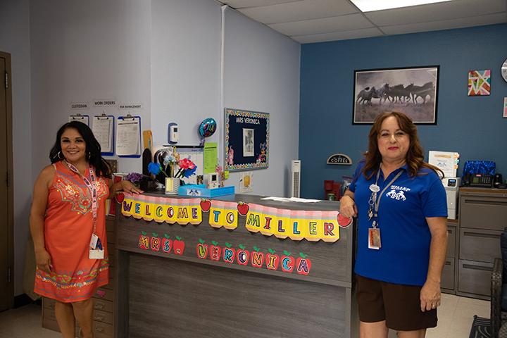 Two women stand by the front desk