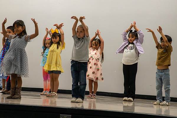 Students perform a dance on stage
