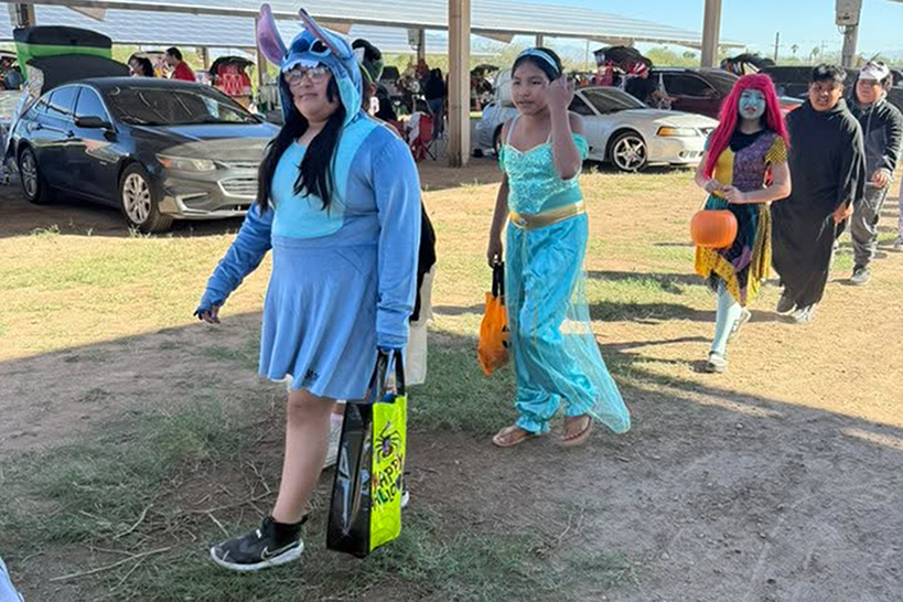 Students parade on the field in their Halloween costumes