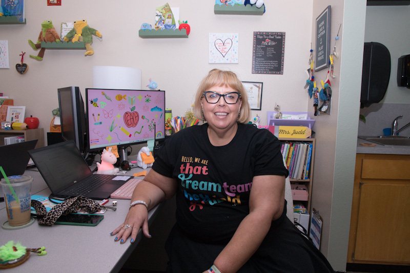 A woman sits at her desk in her classroom